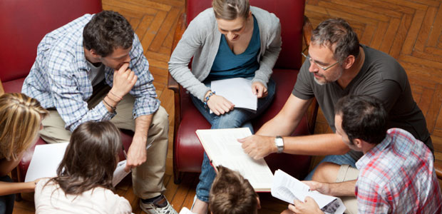 College students meet with a professor in a small study group.