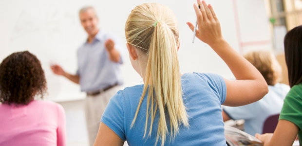 ZAPS presenters engage students with interesting tips and effective techniques for ZAPPING their college entrance exams. Blonde girl raising hand in class while facing the teacher