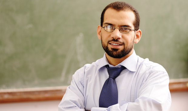Is ZAPS right for your school? Call us to find out. A confident male teacher stands in front of a chalkboard